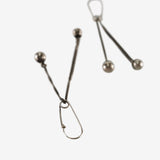 Close up of the silver earrings, showing texture of the silver fabric