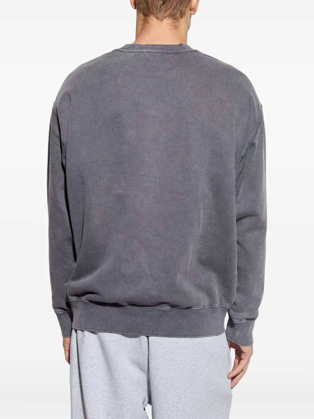 Grey knitwear worn by a person, showing the knitwear fit