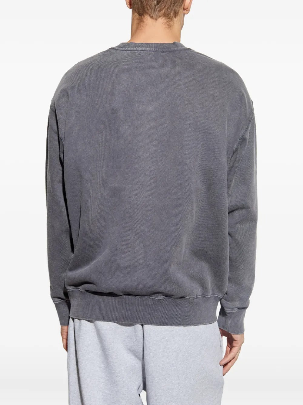 Grey knitwear worn by a person, showing the knitwear fit