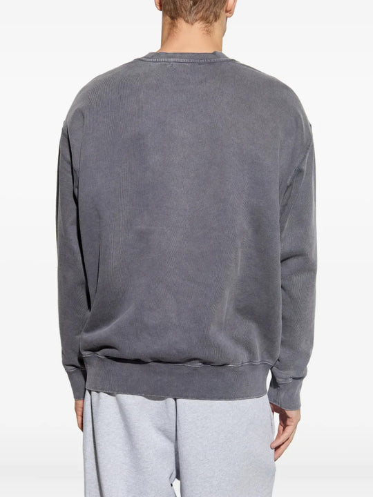 Grey knitwear worn by a person, showing the knitwear fit