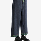 Navy pants worn by a person, showing the pants's fit