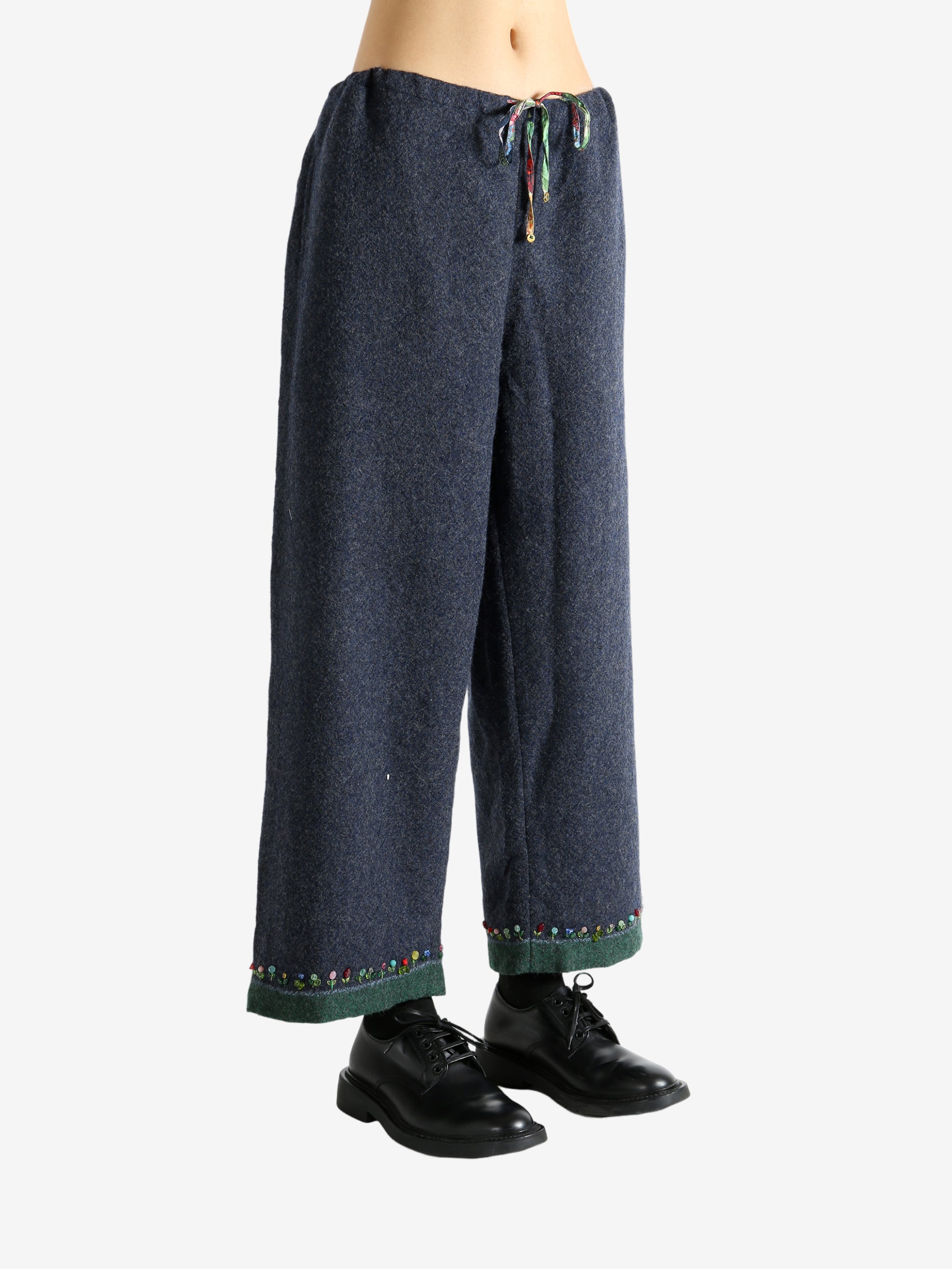 Navy pants worn by a person, showing the pants's fit