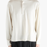 white sweater worn by a person, showing the sweater's fit