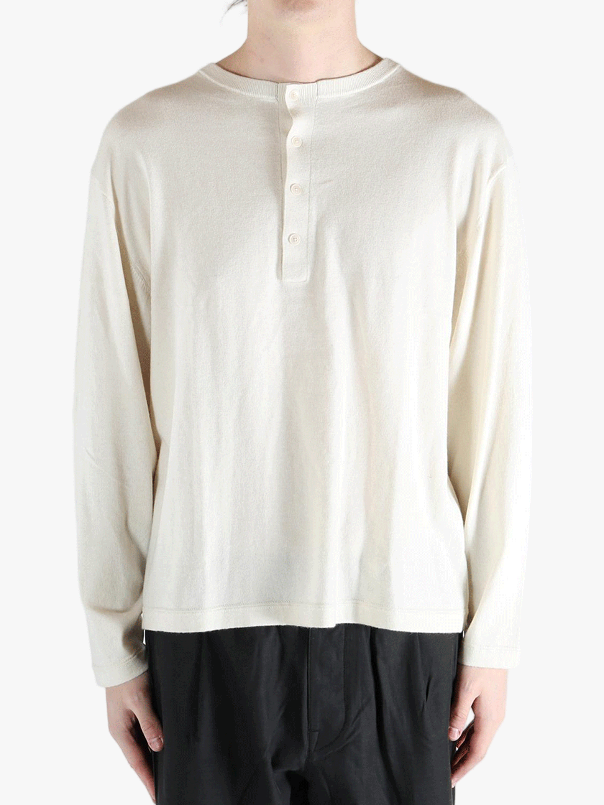 white sweater worn by a person, showing the sweater's fit