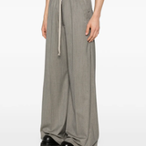 Grey pant worn by a person, showing the pant's fit