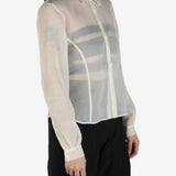 White shirt worn by a person, showing the shirt's fit
