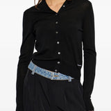 Black knitwear worn by a person, showing the knitwear fit