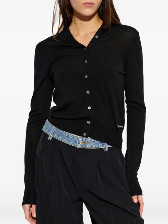 Black knitwear worn by a person, showing the knitwear fit