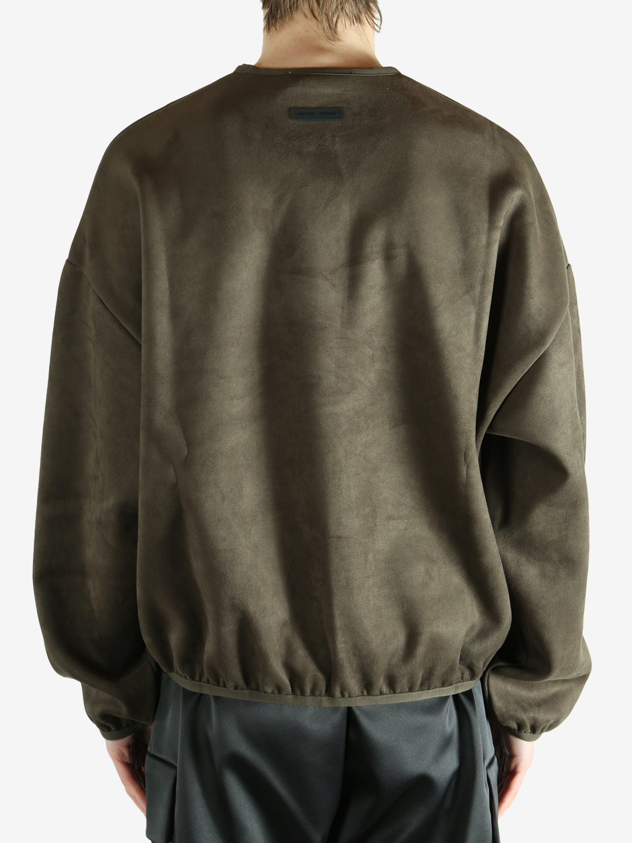 Brown sweatshirt worn by a person, showing the sweatshirt's fit