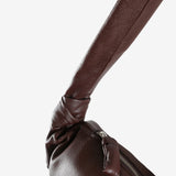 Close up of brown bag, showing texture of the leather fabric