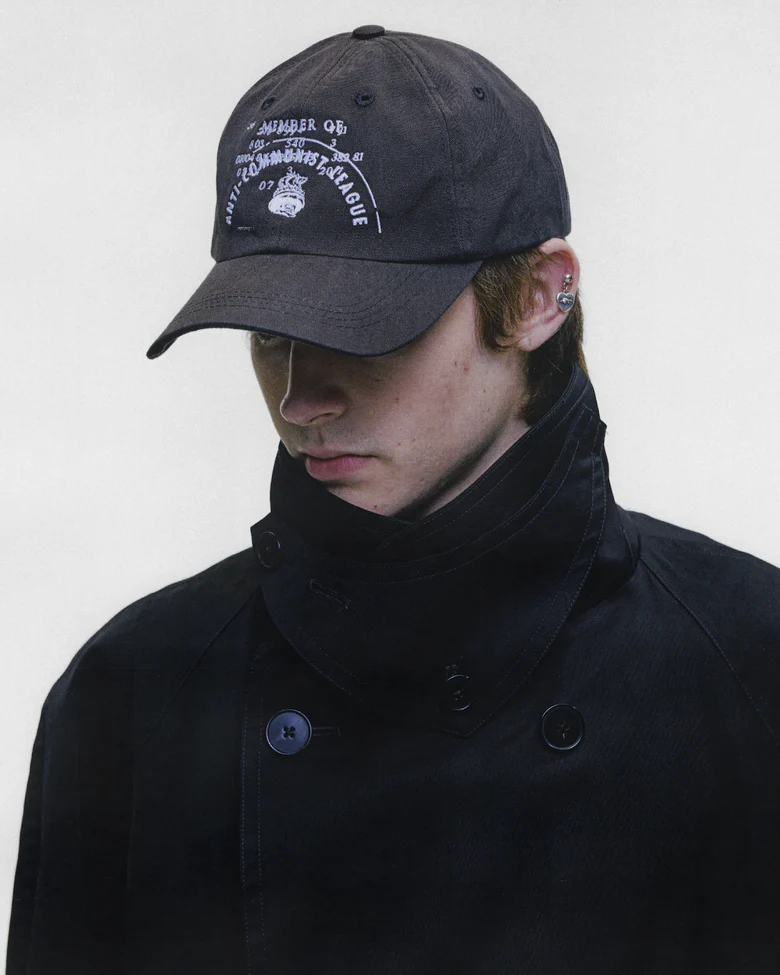 Black hat worn by a person, showing the hat fit