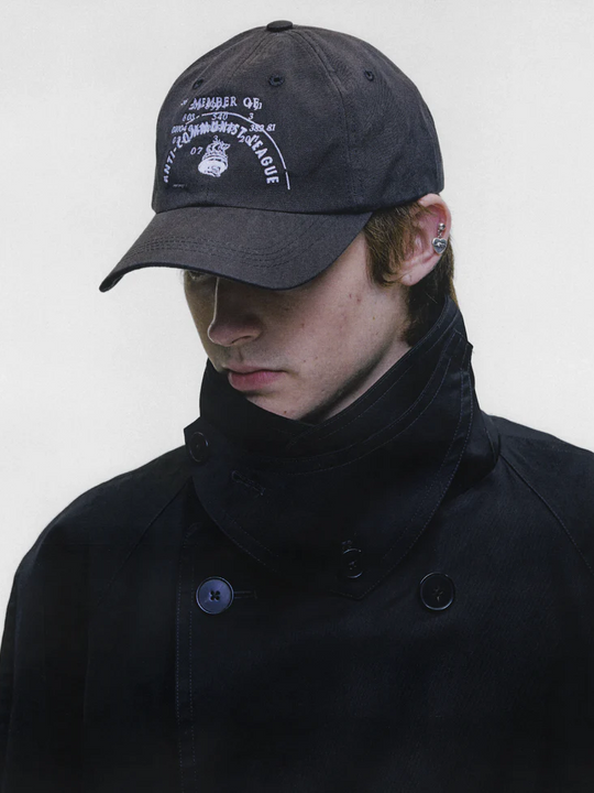 Black hat worn by a person, showing the hat fit