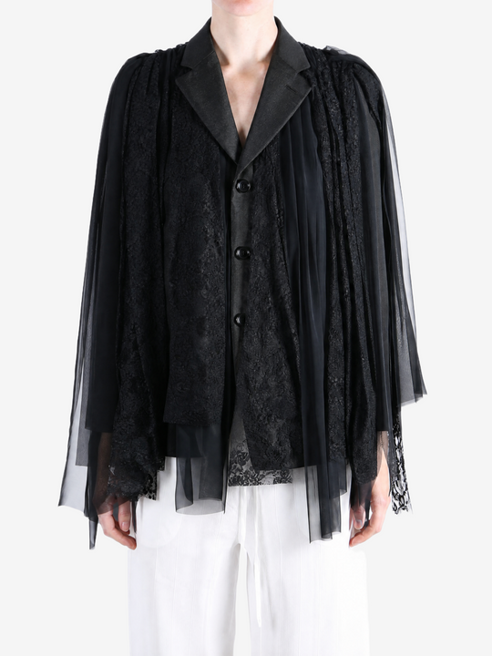 Black jacket worn by a person, showing the jacket fit