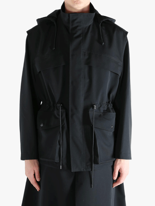 Black jacket worn by a person, showing the jacket fit