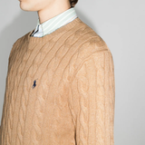 Close up of orange sweater, showing texture of the cotton fabric