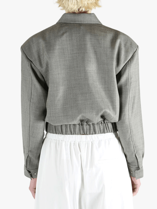 Grey jacket worn by a person, showing the jacket fit