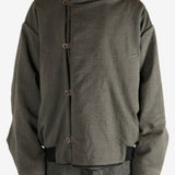 Green jacket worn by a person, showing the jacket's fit