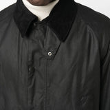 Close up of the black jacket, showing texture of the cotton fabric