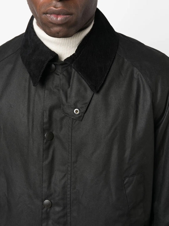 Close up of the black jacket, showing texture of the cotton fabric
