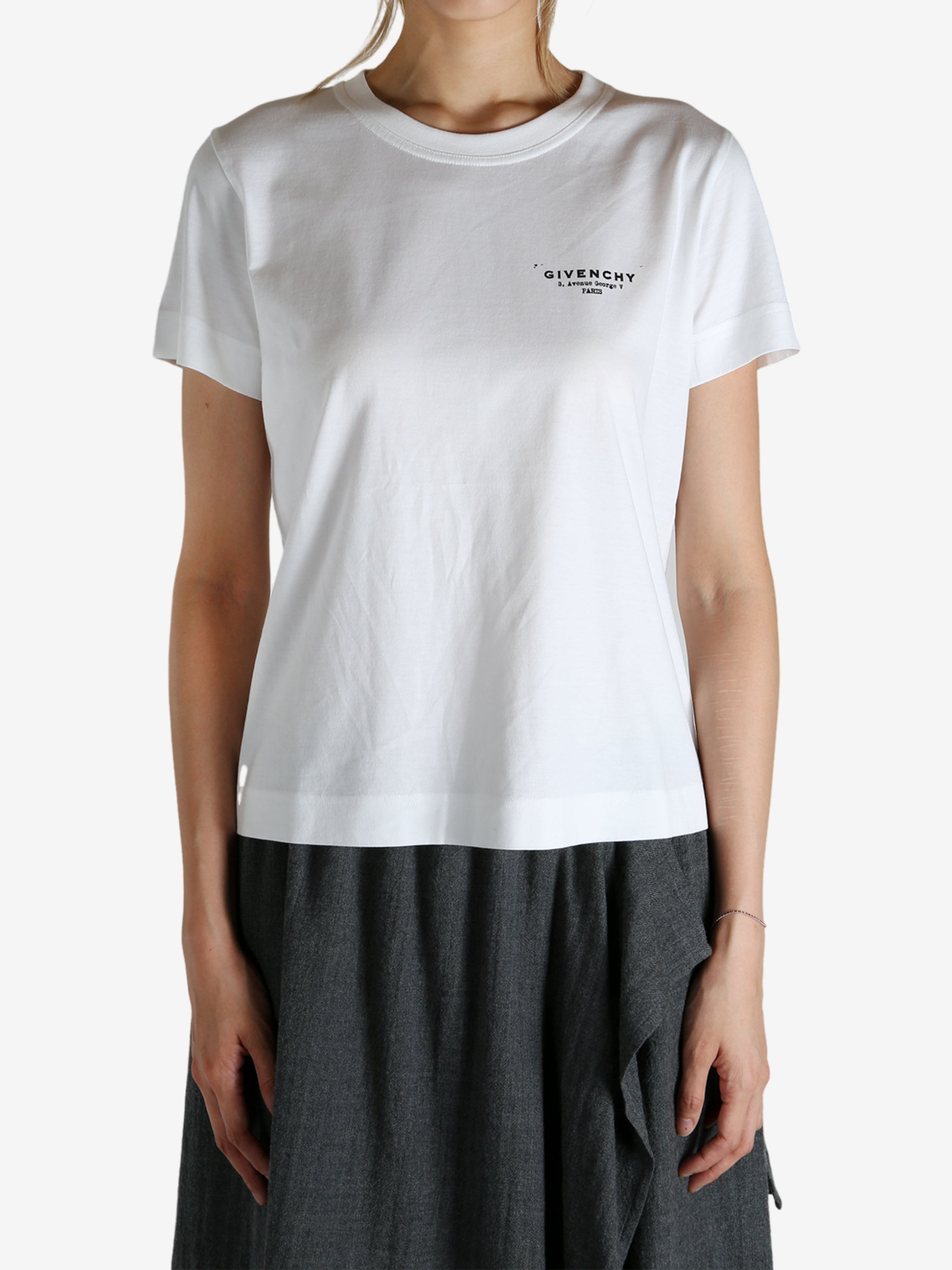 White t-shirt worn by a person, showing the shirt's fit