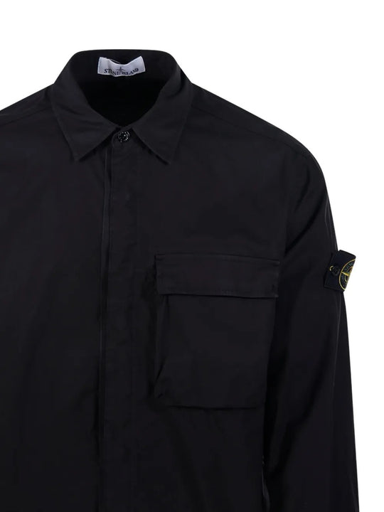 Close up of black shirts, showing texture of the cotton fabric