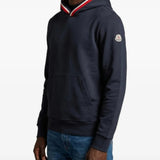Navy hoodie worn by a person, showing the hoodie fit