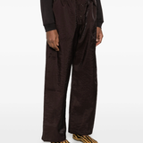 Brown pants worn by a person, showing the pants fit