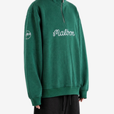 Green hoodie worn by a person, showing the hoodie fit