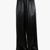 Black pants worn by a person, showing the pant's fit