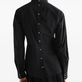 Black top worn by a person, showing the top fit