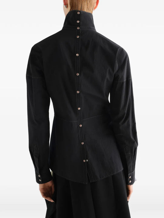 Black top worn by a person, showing the top fit