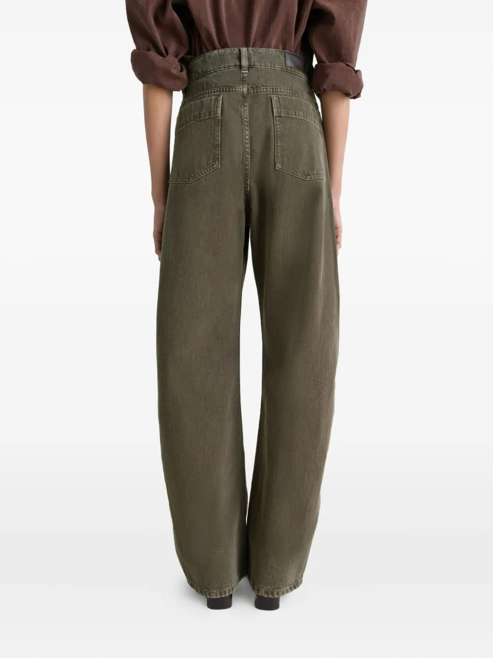 Green jeans worn by a person, showing the jeans' fit