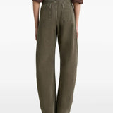 Green jeans worn by a person, showing the jeans' fit