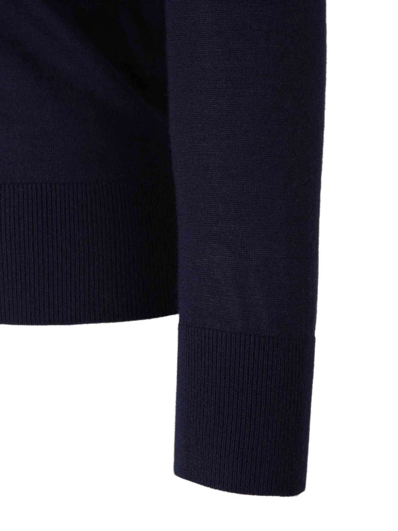 Close up of navy knitwear, showing texture of cashmere and silk fabric