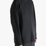 Black jacket worn by a person, showing jacket's fit