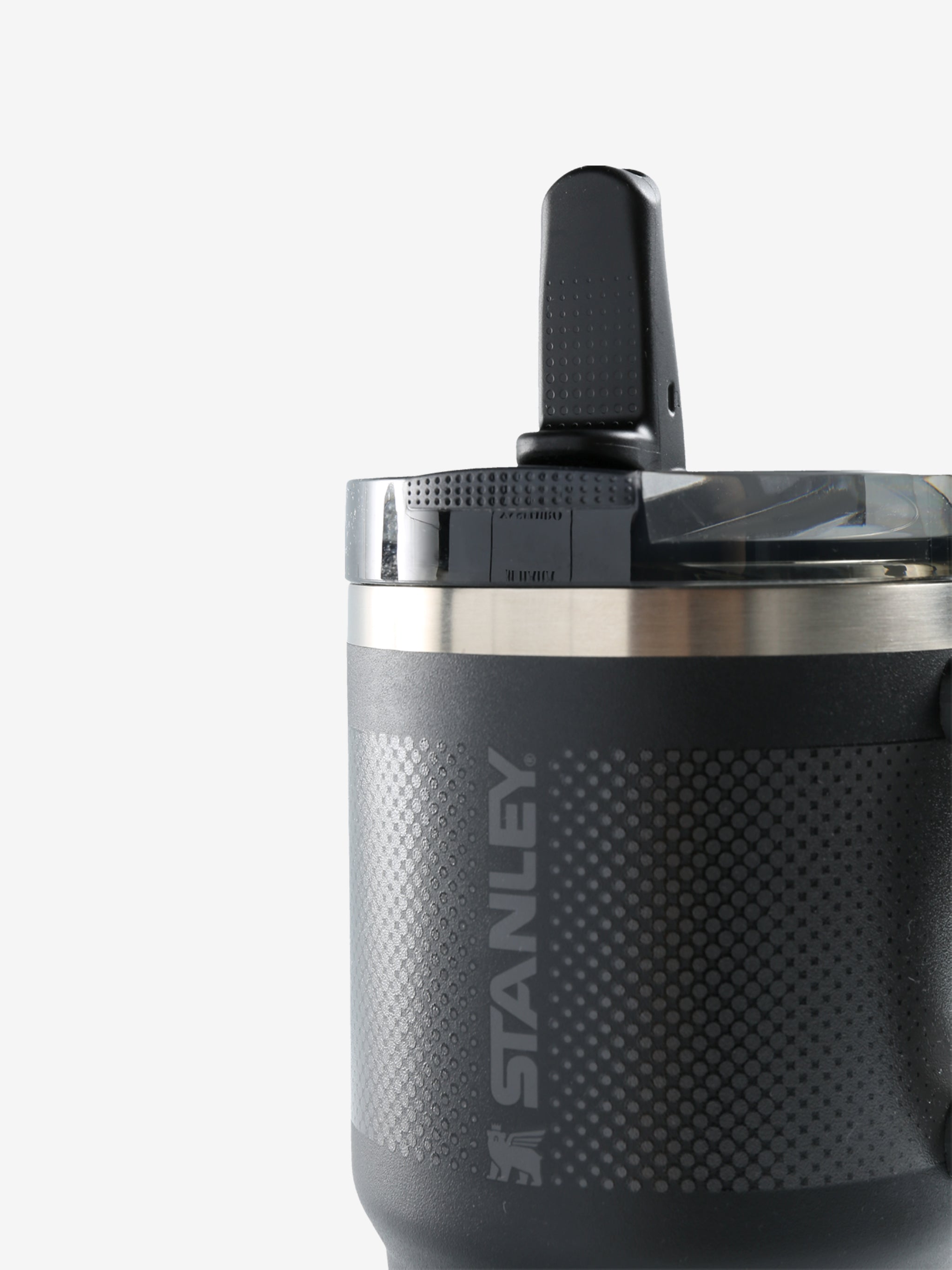 Close up of black tumbler, showing texture of the stainless steel fabric
