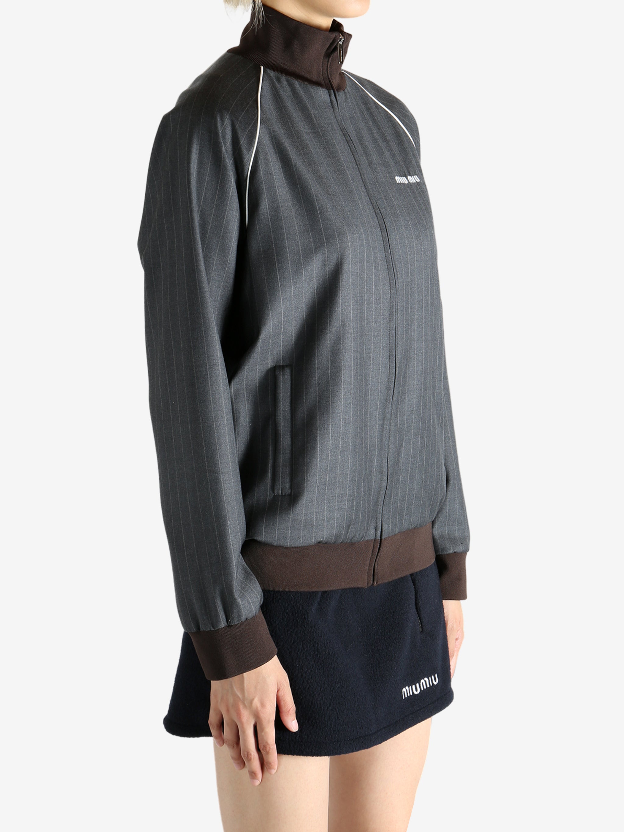 Grey jacket worn by a person, showing the jacket's fit