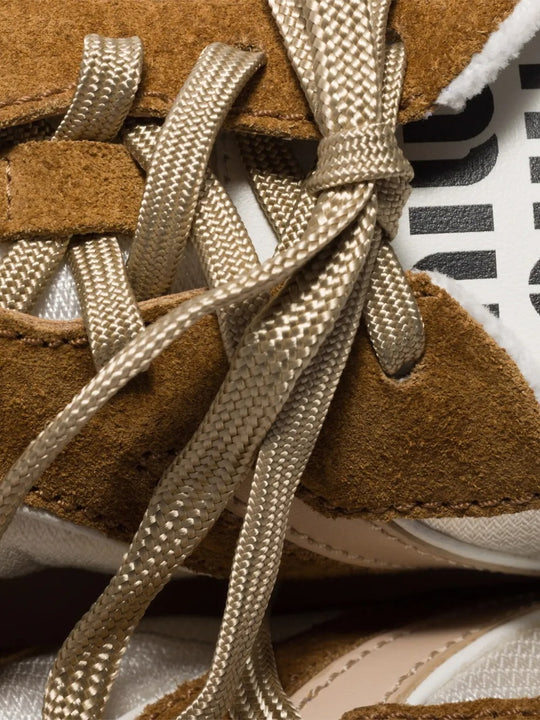 Close up of the brown sneaker, showing texture of the calf suede fabric