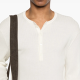 Close up of white knitwear, showing texture of the Cotton fabric