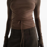 Brown top worn by a person, showing the top fit