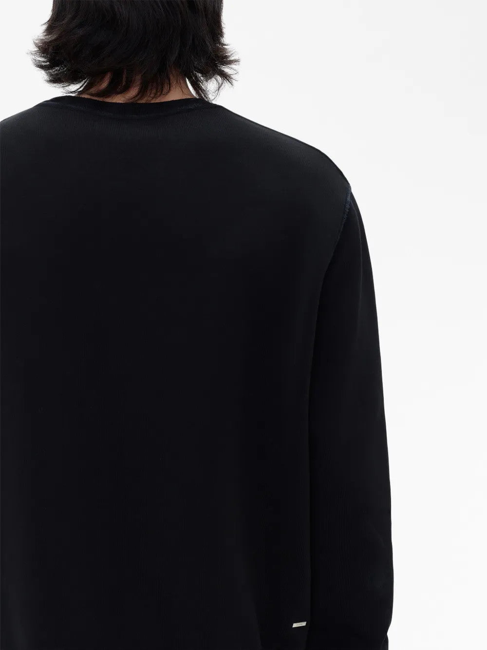 Black t-shirt worn by a person, showing the t-shirt fit