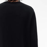 Black t-shirt worn by a person, showing the t-shirt fit