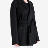 Black jacket worn by a person, showing the jacket fit