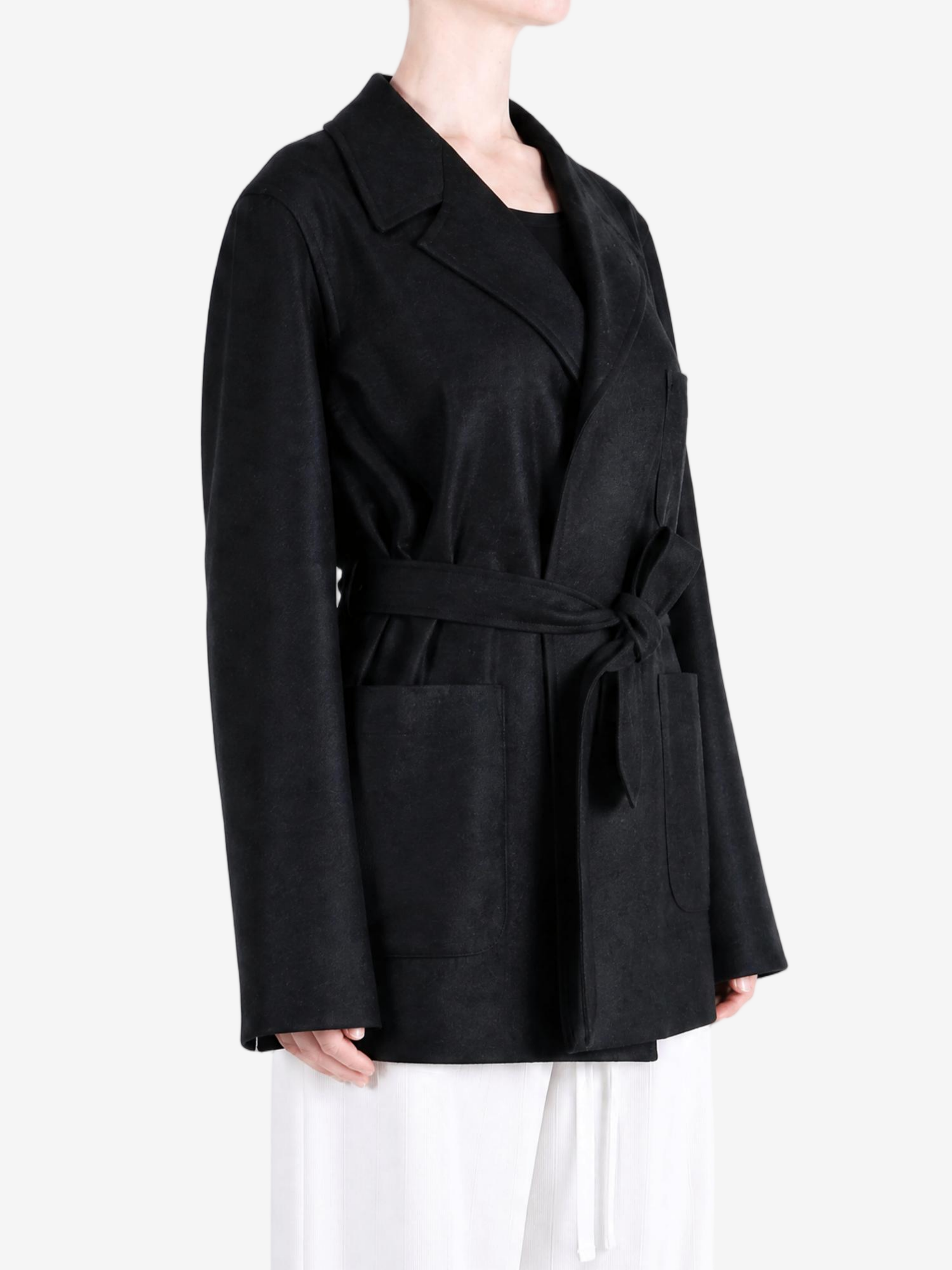 Black jacket worn by a person, showing the jacket fit