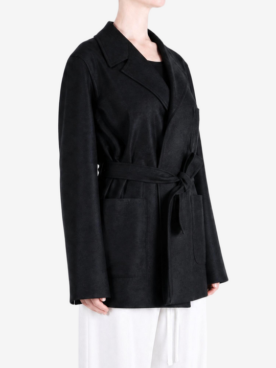 Black jacket worn by a person, showing the jacket fit