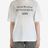 White t-shirt worn by a person, showing the t-shirt's fit