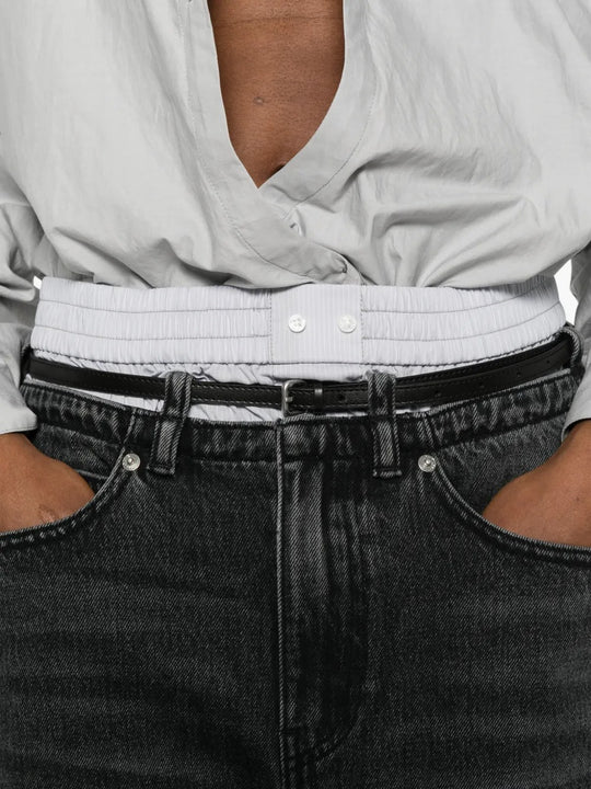 Close up of grey jeans, showing texture of the cotton fabric