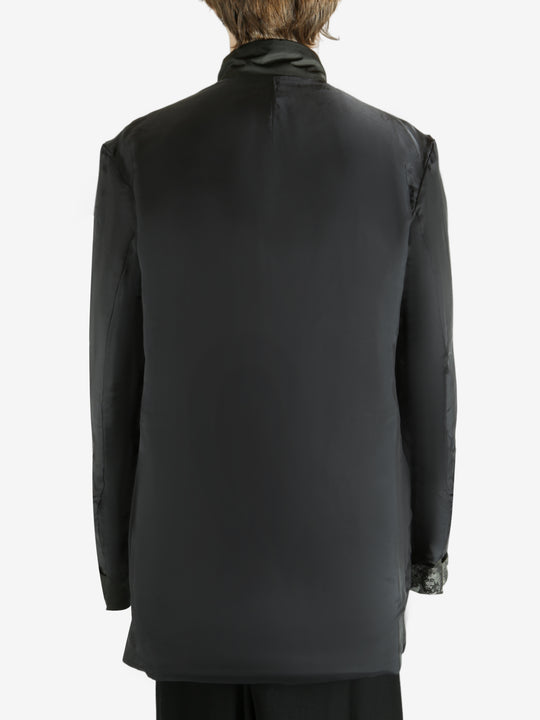 Black jacket worn by a person, showing the jacket's fit