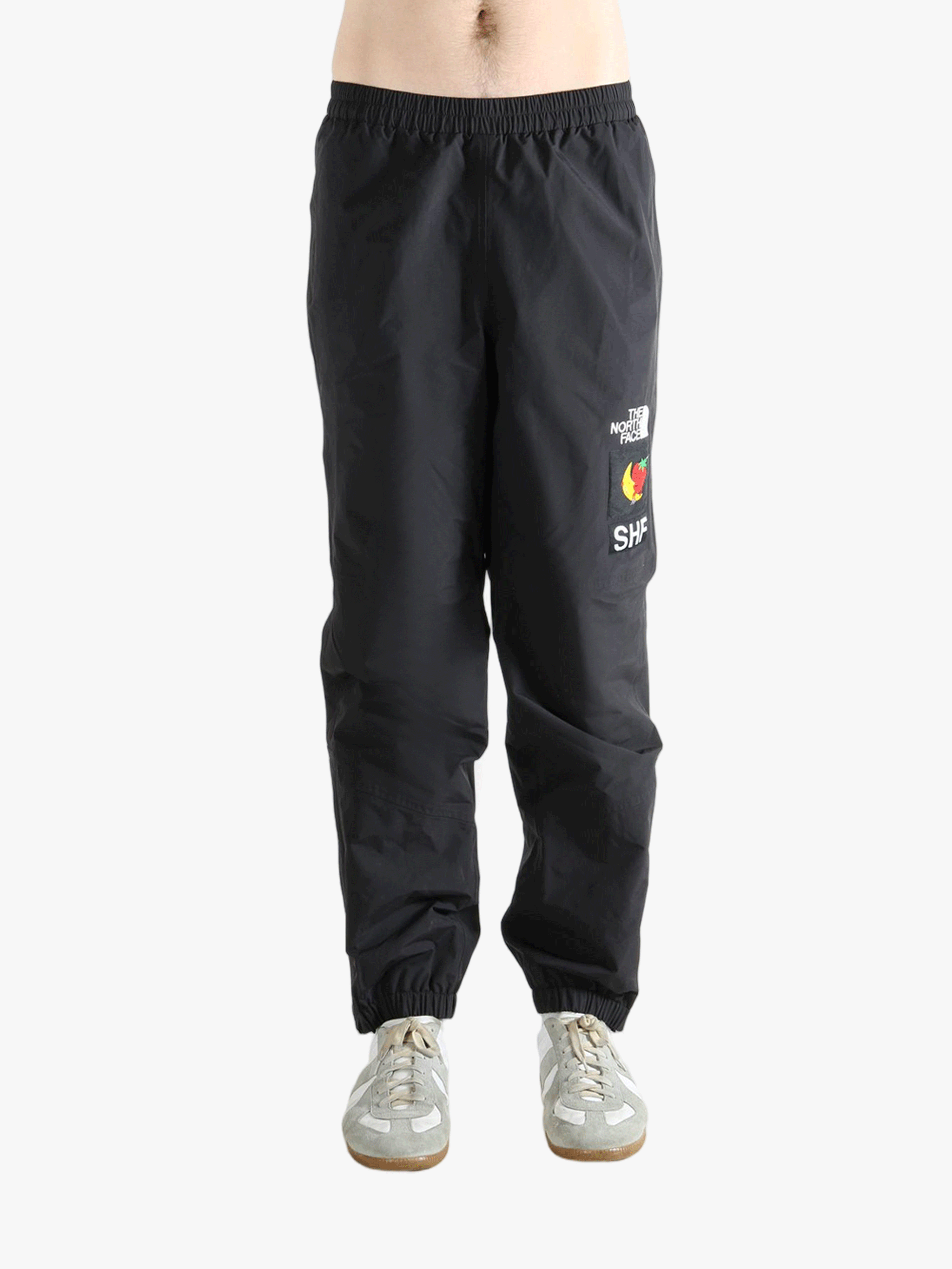 Black pants worn by a person showing the pants fit