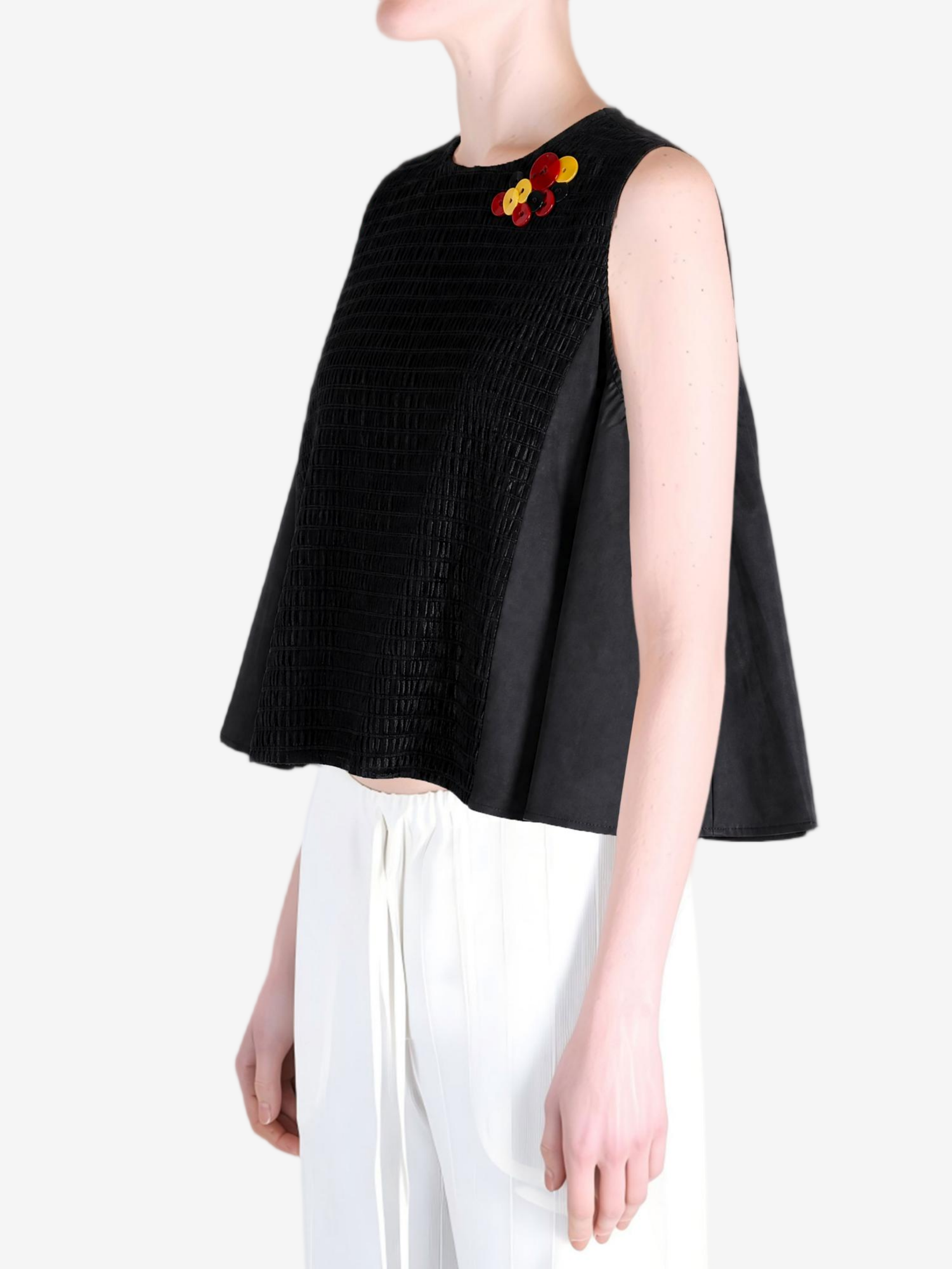 Black top worn by a person, showing the top fit
